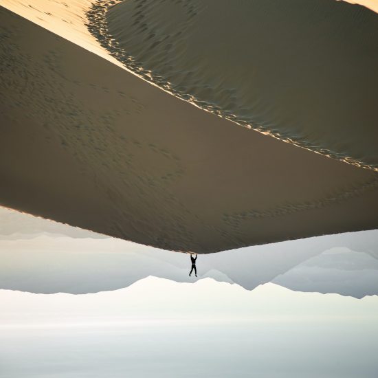 photo-of-man-doing-handstand-on-desert-2404368